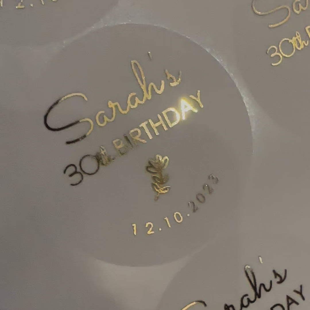 Load video: Personalised Flower themed Birthday Stickers with name and date moving to show the high shine gold foil finish
