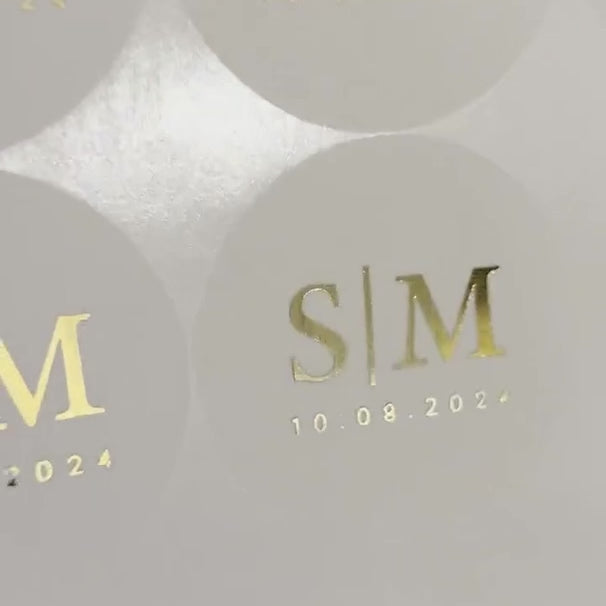 Load video: Personalised Initial Monogram Wedding Stickers with date moving to show the high shine gold foil finish