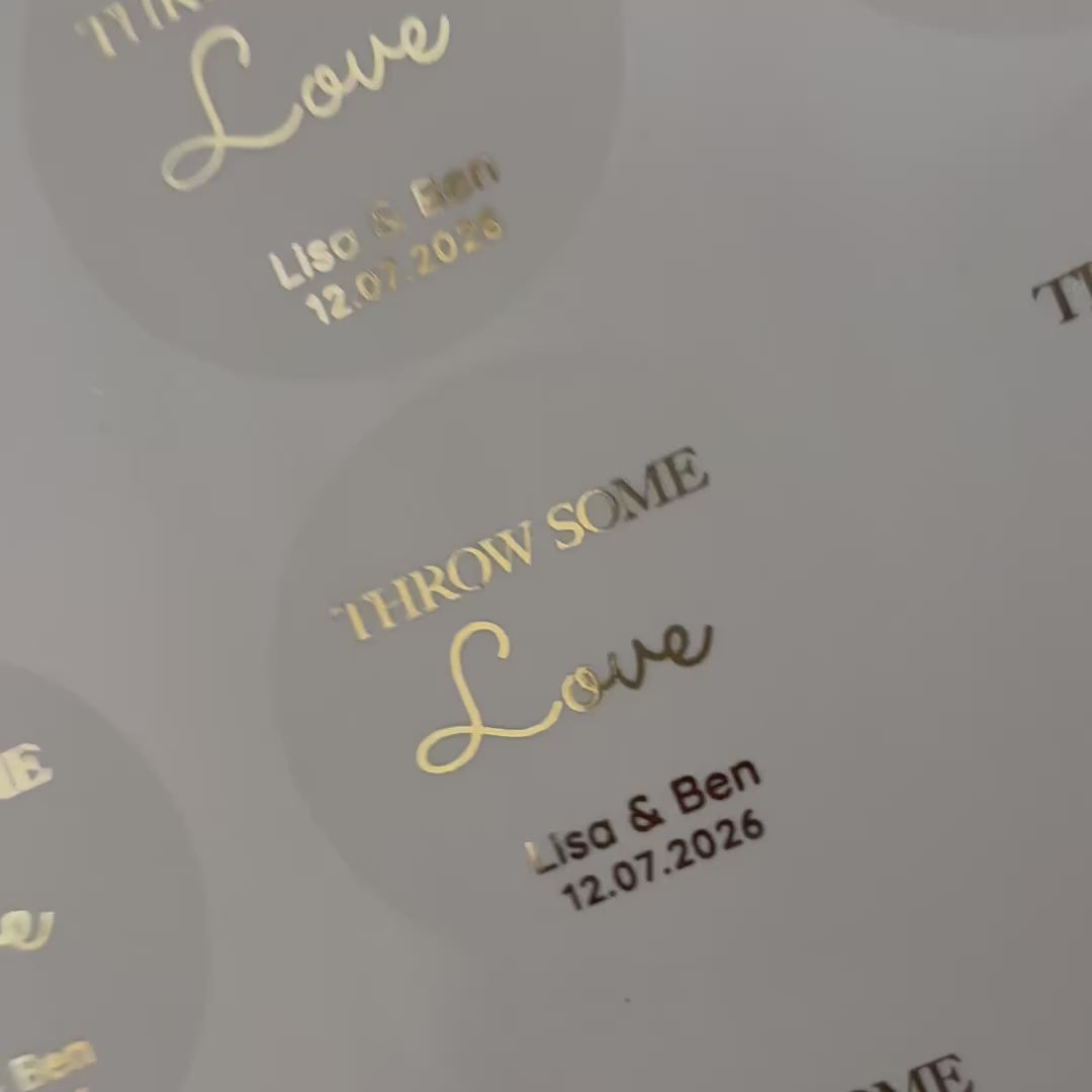 Load video: Personalised 'throw some love' Wedding Stickers with names and date moving to show the high shine gold foil finish