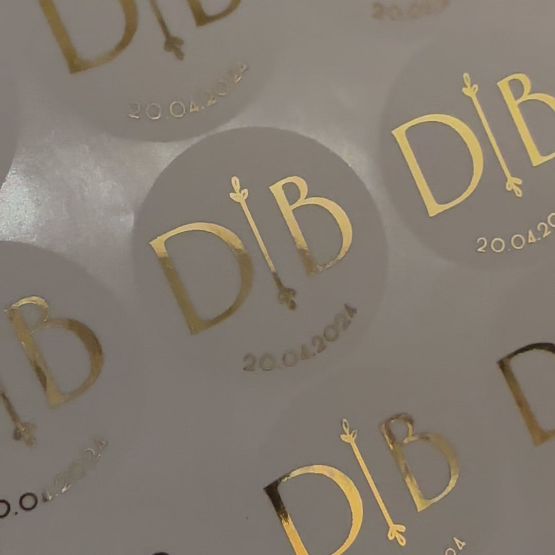 Load video: Personalised Initial Monogram Wedding Stickers moving to show the high shine gold foil finish