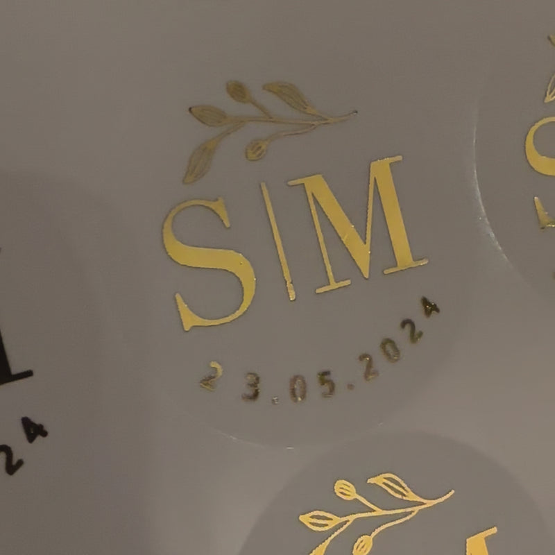 Personalised Initial Monogram Wedding Stickers moving with floral theme to show the high shine gold foil finish