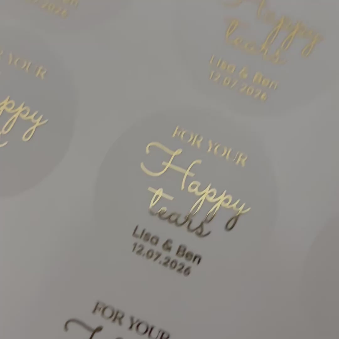 Load video: Personalised &#39;happy tears&#39; Wedding Stickers with names and date moving to show the high shine gold foil finish