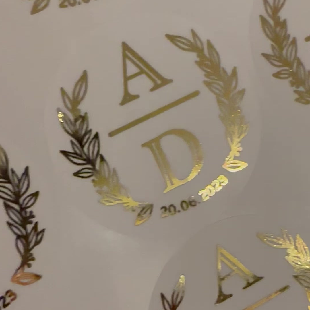Load video: Personalised Initial Monogram Wedding Stickers moving to show the high shine gold foil finish