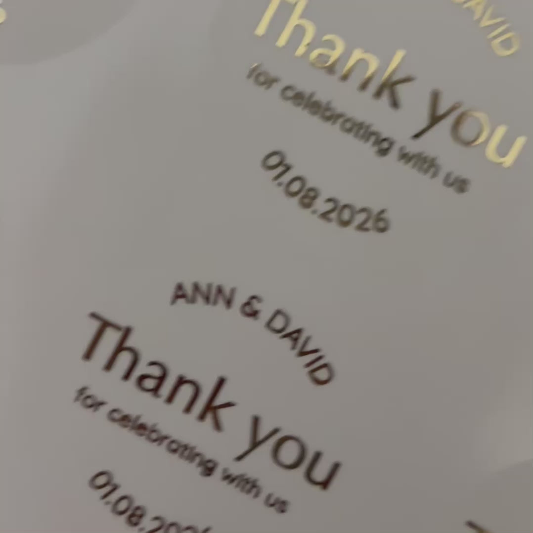 Load video: Personalised &#39;thank you for celebrating with us&#39;&#39; Wedding Stickers with names and date moving to show the high shine gold foil finish